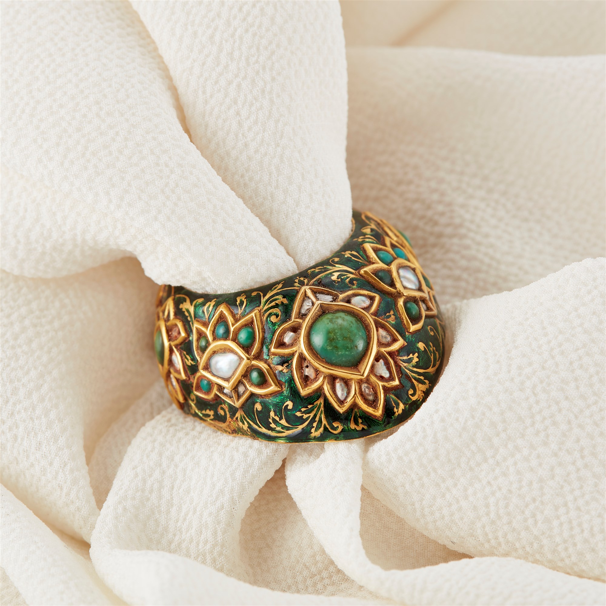A Mughal gem-set and enamelled gold archer's ring set with turquoise, North India, 19th century