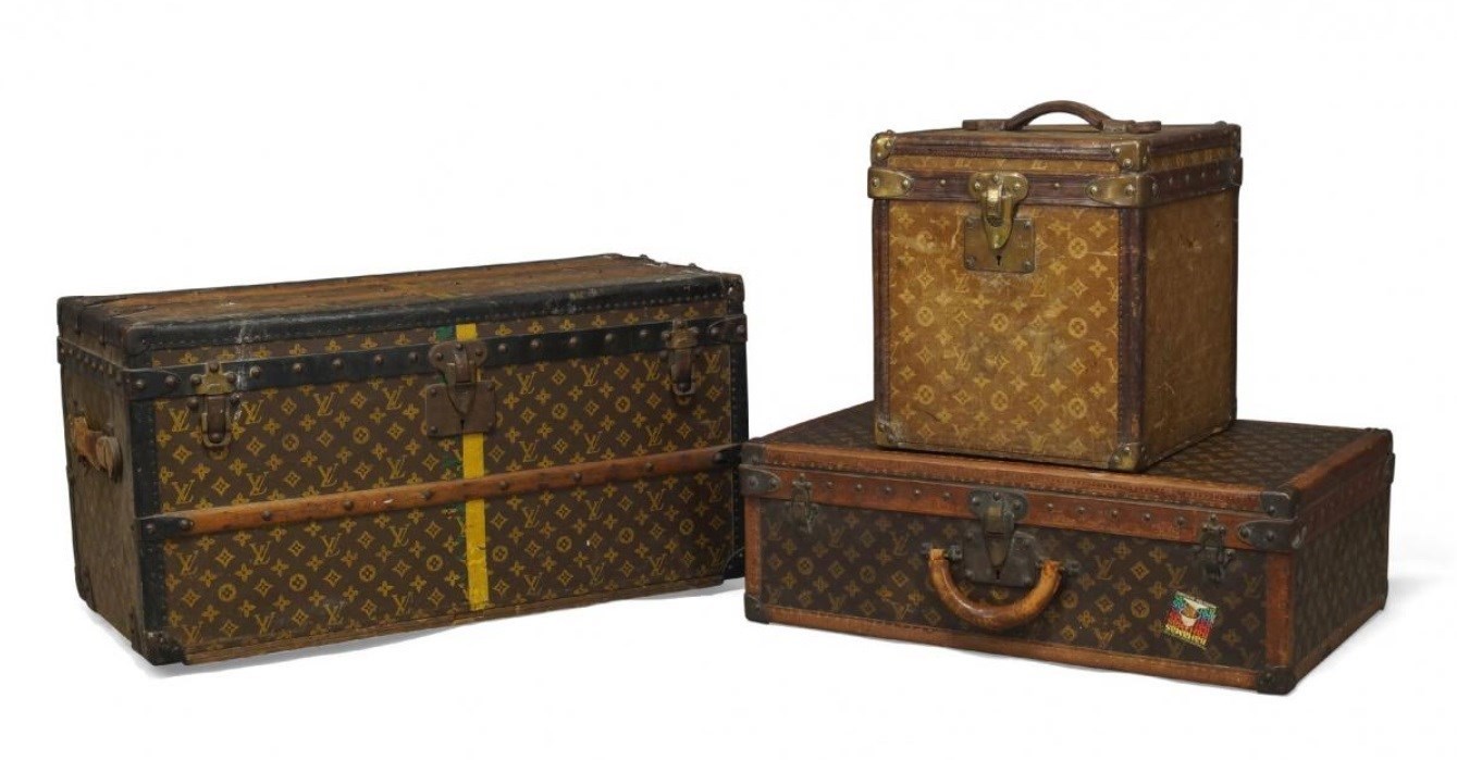 A Louis Vuitton suitcase, covered in LV monogrammed fabric