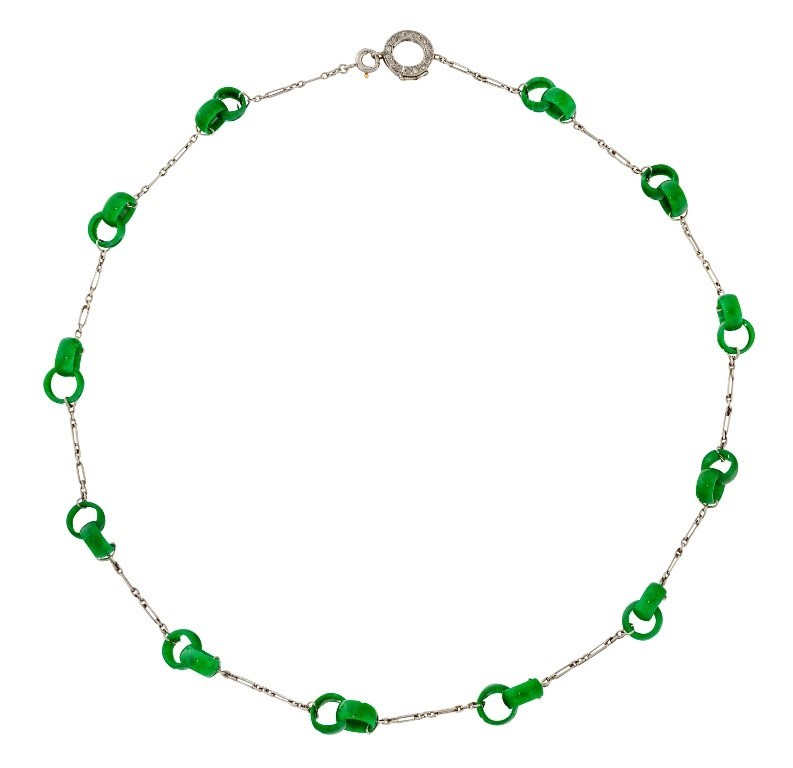 A Belle Epoque platinum and jadeite jade necklace, designed as a platinum fine link neckchain with intervals of twelve carved jadeite interlocking twin hoops to a platinum and rose-cut diamond circular hoop clasp, c.1915. Up for sale in Roseberys Jewellery & Watches auction on 8 June 2021.