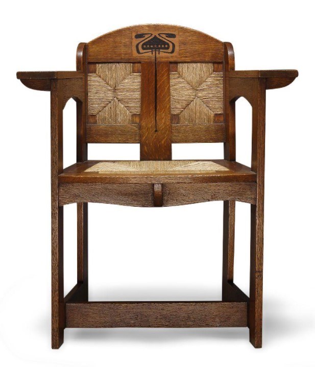 E.G. Punnett (British), and Art & Crafts inlaid oak and rush seated arm chair made by William Birch of High Wycombe c.1901